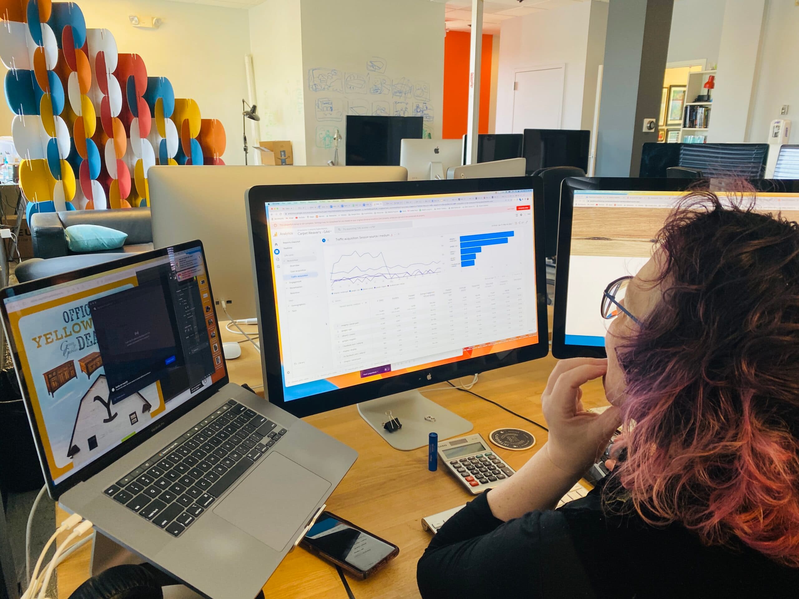 Woman looking at computer monitor with GA4 reports
