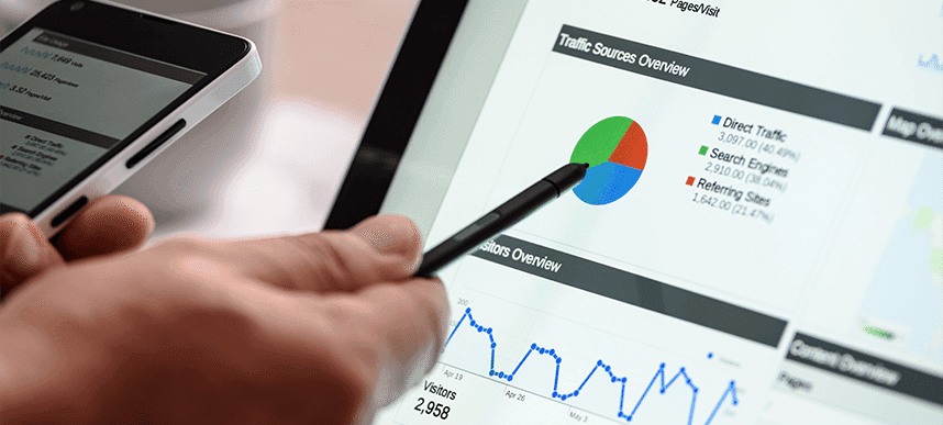 A pen pointing at a website traffic chart on a tablet