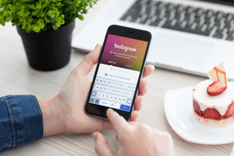 Person holding a smart phone logging into Instagram.