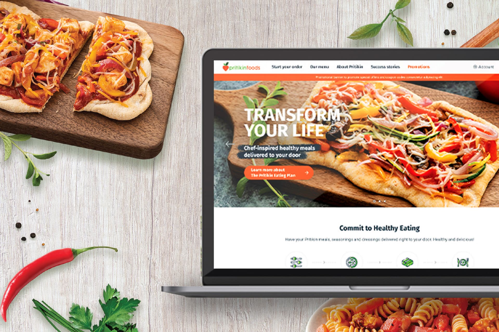 Pritikin website, “Transform your life,” on a laptop beside pizza and vegetables