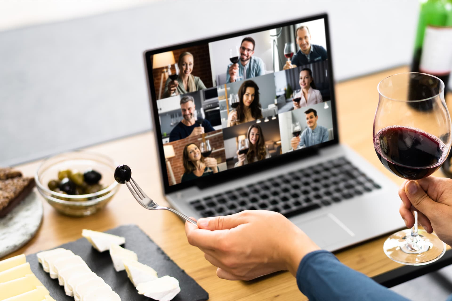 A virtual wine tasting with a group on a laptop video call