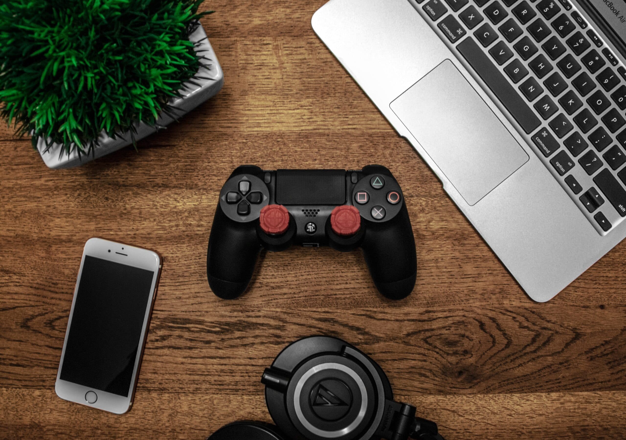 Overhead image of a desk with laptop and gaming controller
