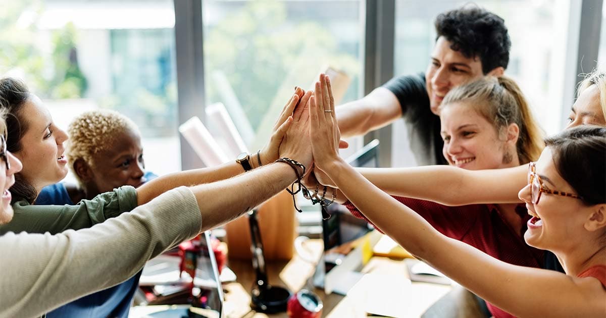 Group of employees high-fiving