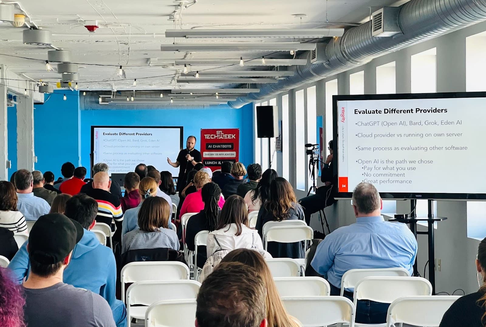 Audience watching a presentation at the STL TechWeek AI chatbot lunch and learn