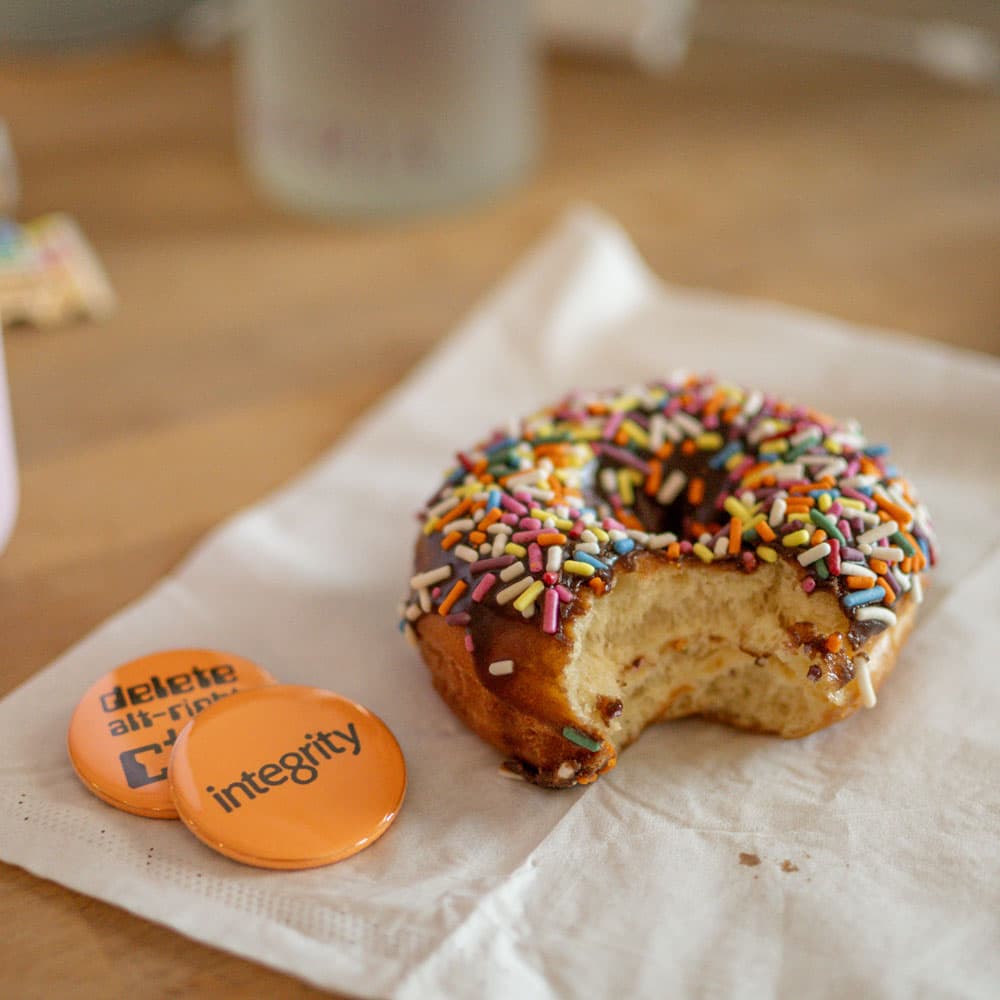 A sprinkle doughnut beside IntegrityXD buttons