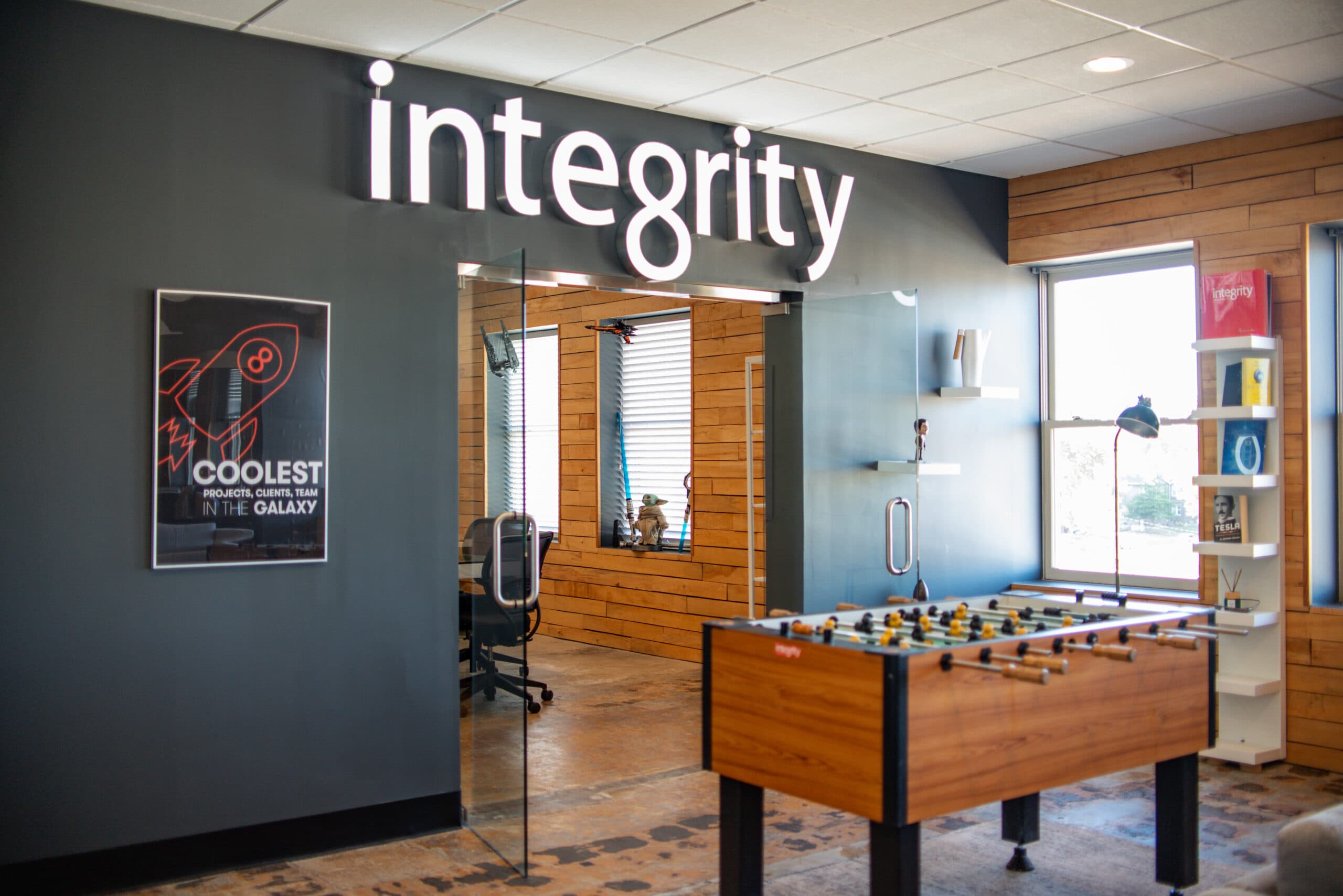 IntegrityXD lobby with the integrity logo on the wall and a foosball table